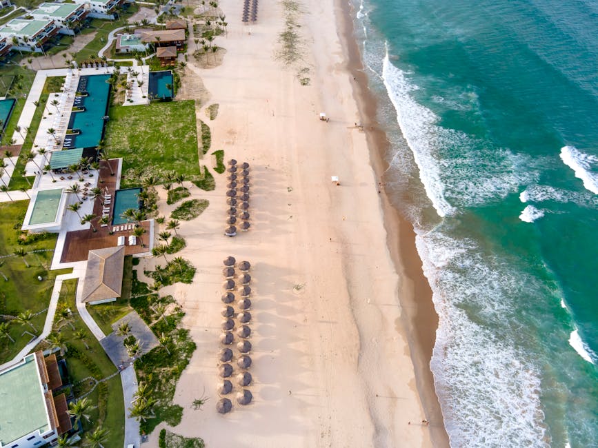 A breathtaking aerial shot of a tropical beach resort with turquoise waters and sandy shores.