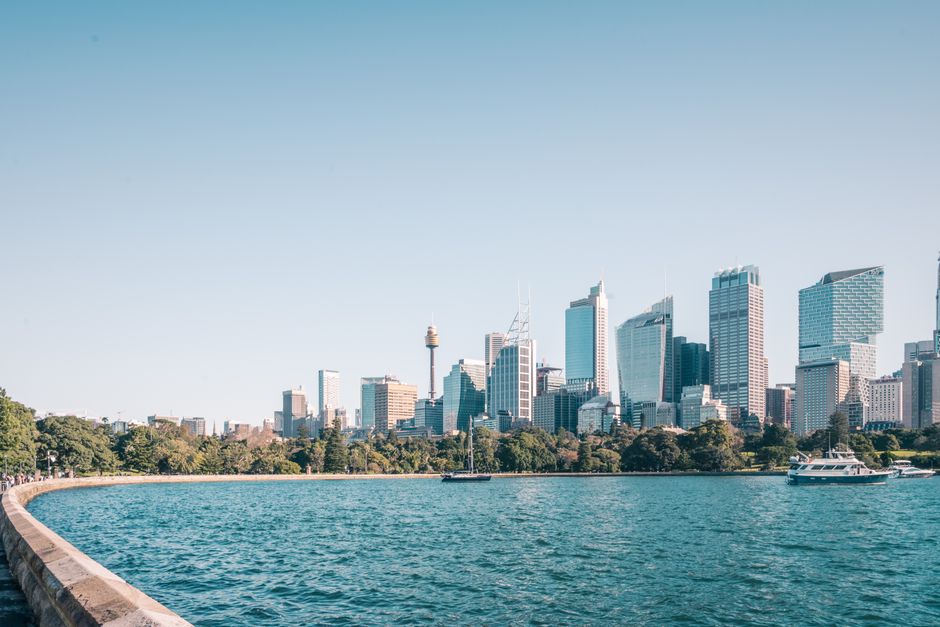 Breathtaking view of Sydney's skyline with iconic skyscrapers and harbor waters.