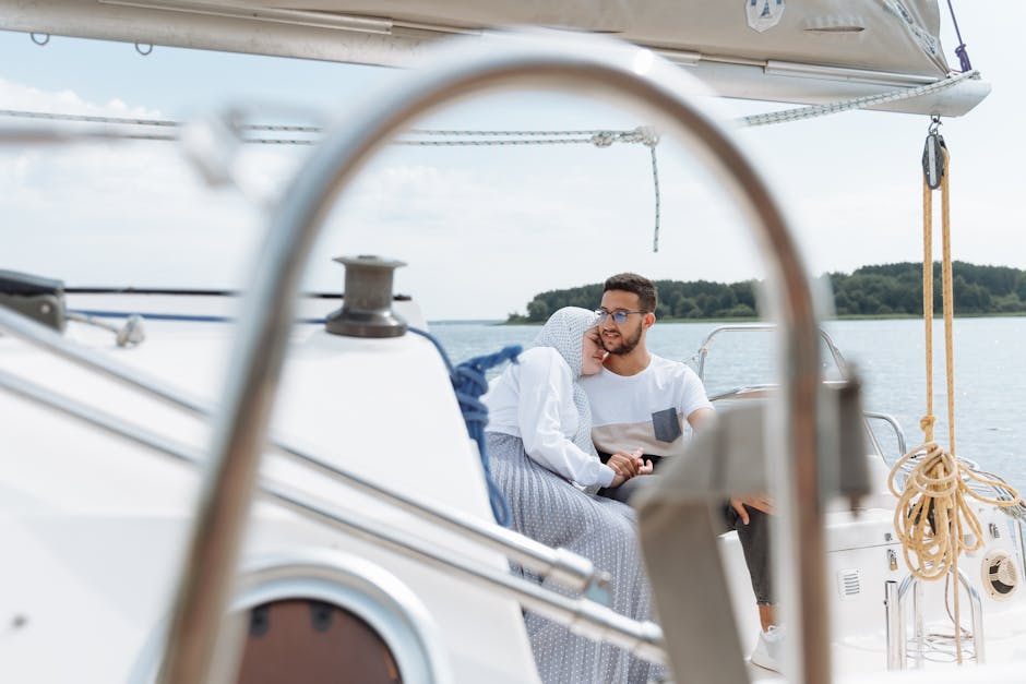 Muslim couple enjoying a romantic moment sailing on a yacht during a peaceful day.