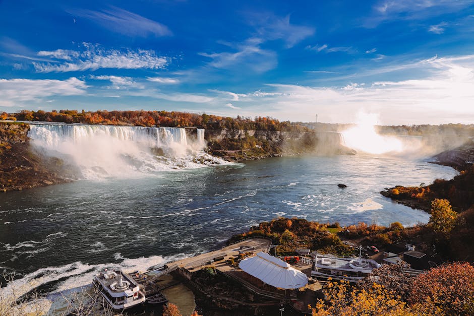 Capture the breathtaking beauty of Niagara Falls with vibrant autumn colors and cascading waterfalls.