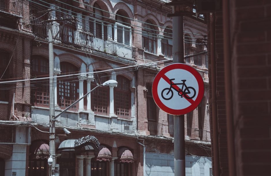 Street scene featuring a no bicycle sign against a backdrop of vintage architecture.