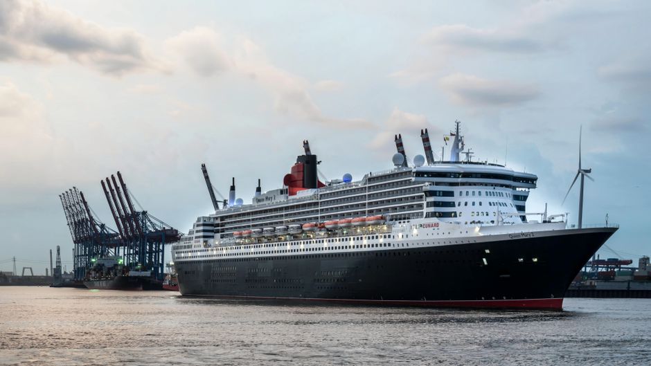 A majestic cruise ship docked in Hamburg harbor during sunrise, capturing the serene waters and industrial backdrop.