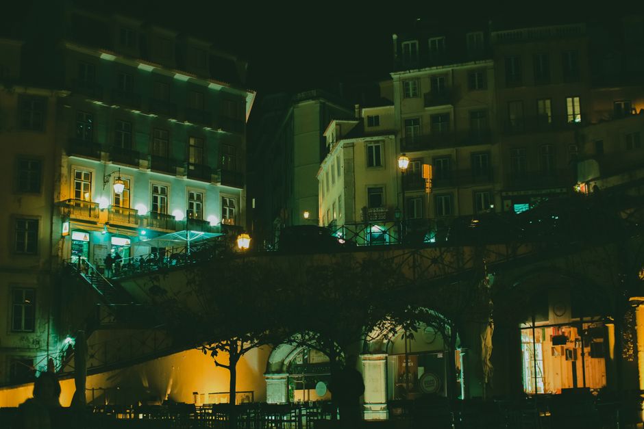 Explore modern residential buildings illuminated at night, showcasing urban architecture and street lighting.