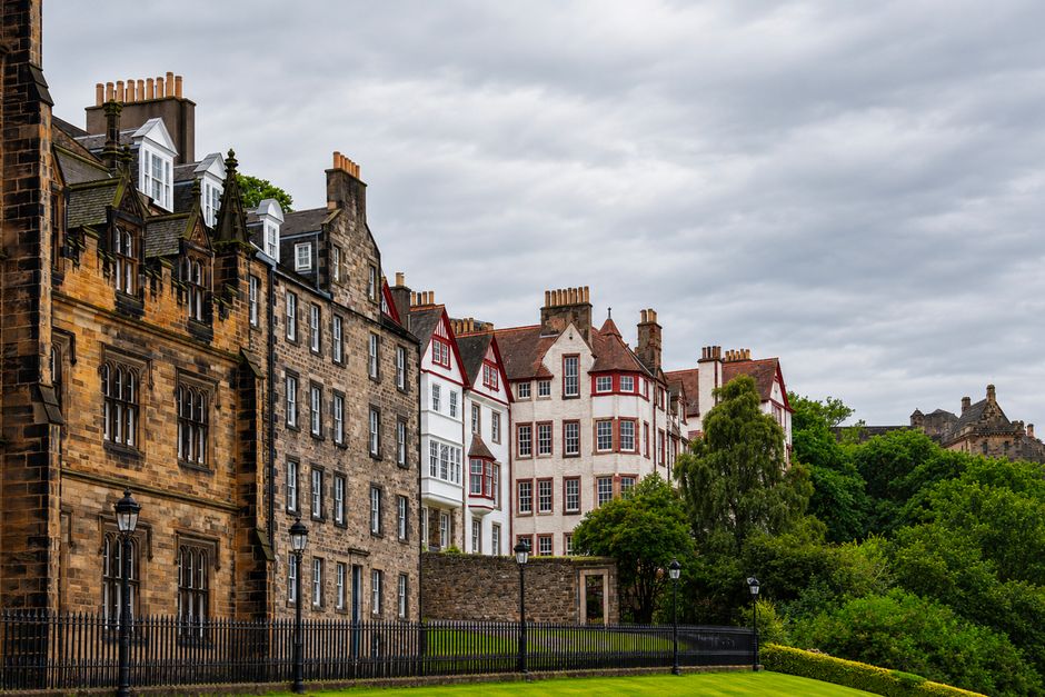 Charming view of historic buildings in Edinburgh's Old Town with lush greenery.