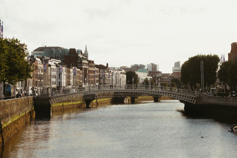 Scenic view of Dublin's Ha'penny Bridge over the River Liffey, showcasing charming city architecture.
