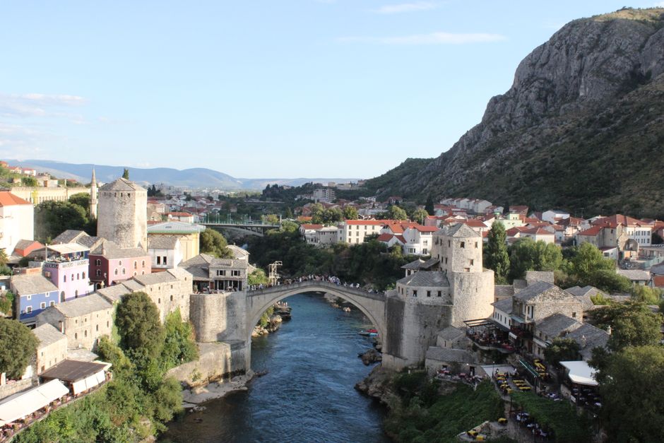 Scenic aerial view of Mostar's Old Bridge and surrounding architecture in summer.