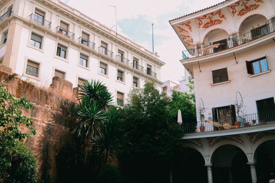 Beautiful blend of classic Andalusian architecture in Seville, Spain showcasing lush greenery and detailed facades.